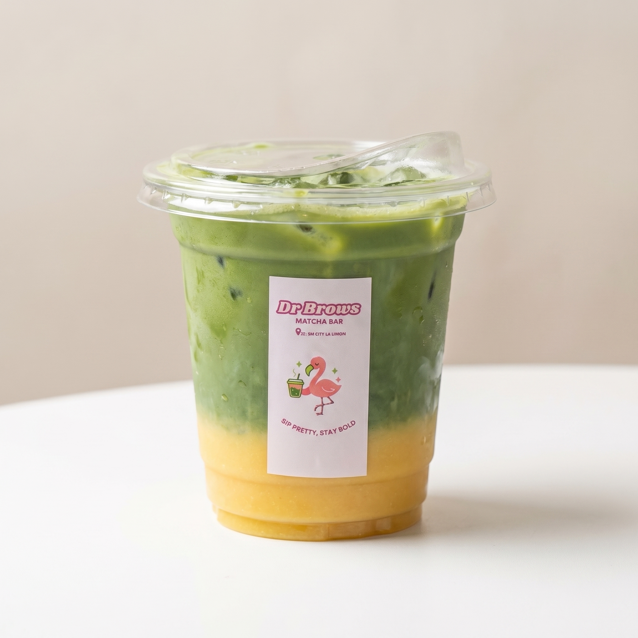 A finished Dr. Brows Matcha Bar iced matcha with the signature flamingo label